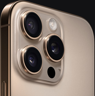 沙漠色钛金属 iPhone 16 Pro 的背面特写视图，展示摄像头和侧边按钮。